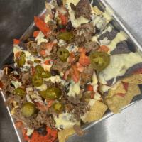 Nacho Average Nachos · Tortilla chips topped with black beans, jalapenos, pico de gallo and spiced cheddar smothere...