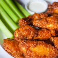 Chicken Wings · Crispy deep fried wings tossed in your choice of housemade sauce. Served with a side of cele...