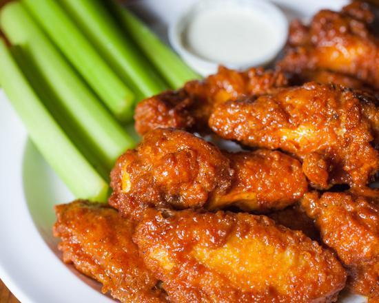 Chicken Wings · Crispy deep fried wings tossed in your choice of housemade sauce. Served with a side of celery and ranch or bleu cheese.