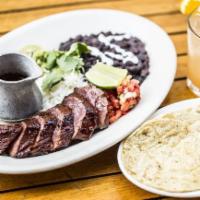 Filet Mignon Steak Tacos · Build-you-own tacos are served with sliced filet mignon steak, white rice, black beans, sour...