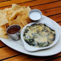 Artichoke Dip · Gooey spinach and artichoke dip is baked until golden and bubbly. Served with corn tortilla ...