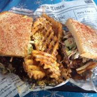 The Jessie Rae Sandwich · Pulled pork stacked on top of utani bread. Vegas slaw and BBQ chips.