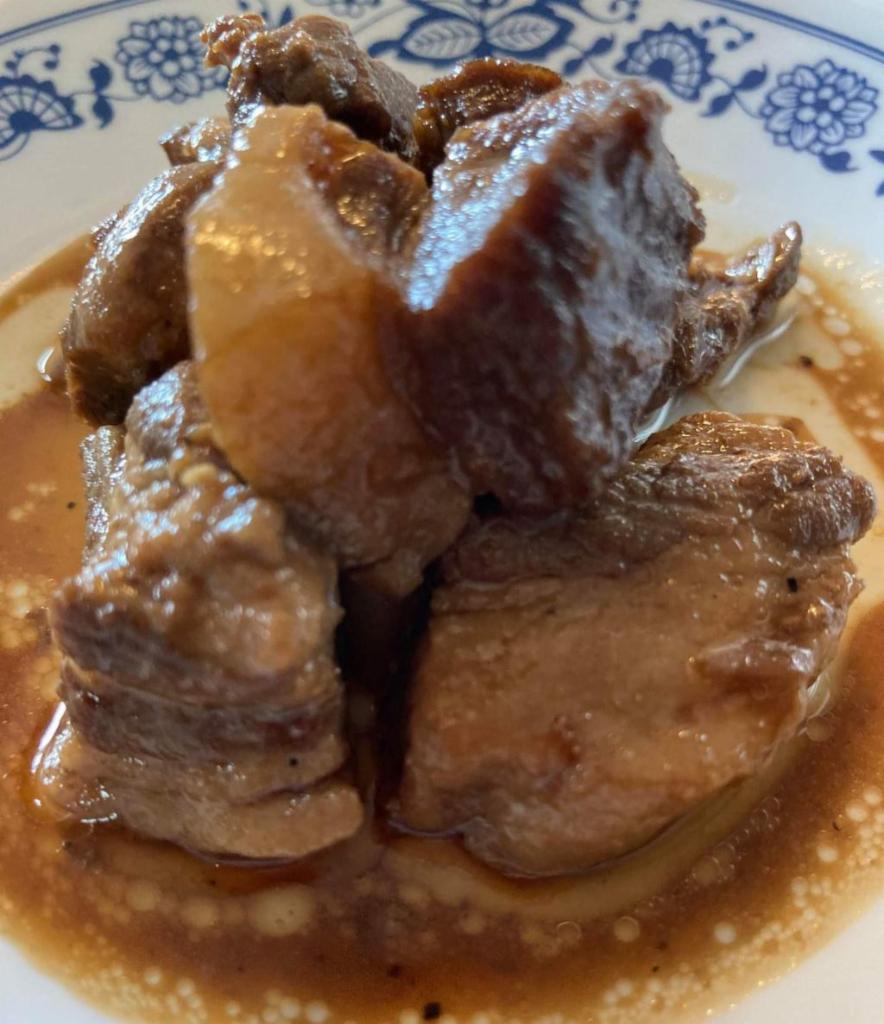 Pork Adobo · Pork Adobo originated in the Philippines. It's a braised pork recipe with vinegar, soy sauce and garlic, and is delicious over steamed rice. served with  2 lumpia