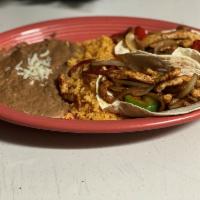 Taco Fajita · 2 flour tortillas filled with grilled chicken or steak, grilled peppers and onions served wi...