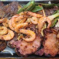 Parrillada Mar y Tierra (Double) · Grilled chicken, steak, chorizo, pork chuletas, fish fillet, beef ribs, shrimp, onions, jala...