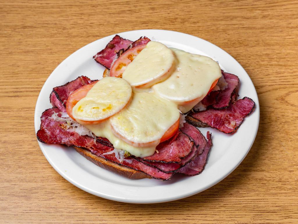 Reuben Sandwich · Corned beef or pastrami on grilled rye bread with sauerkraut, melted Swiss cheese and mustard.