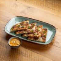 Quarter Stacks of Scallion - Scallion Pancakes · Pan fried Chinese savory flat bread folded with scallions.
Served with yellow curry sauce.
C...