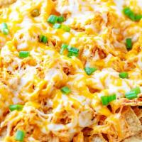 N1. Nachos with Cheese · Vegetarian. Homemade white corn tortilla chips coated with melted cheese, jalapenos, black b...