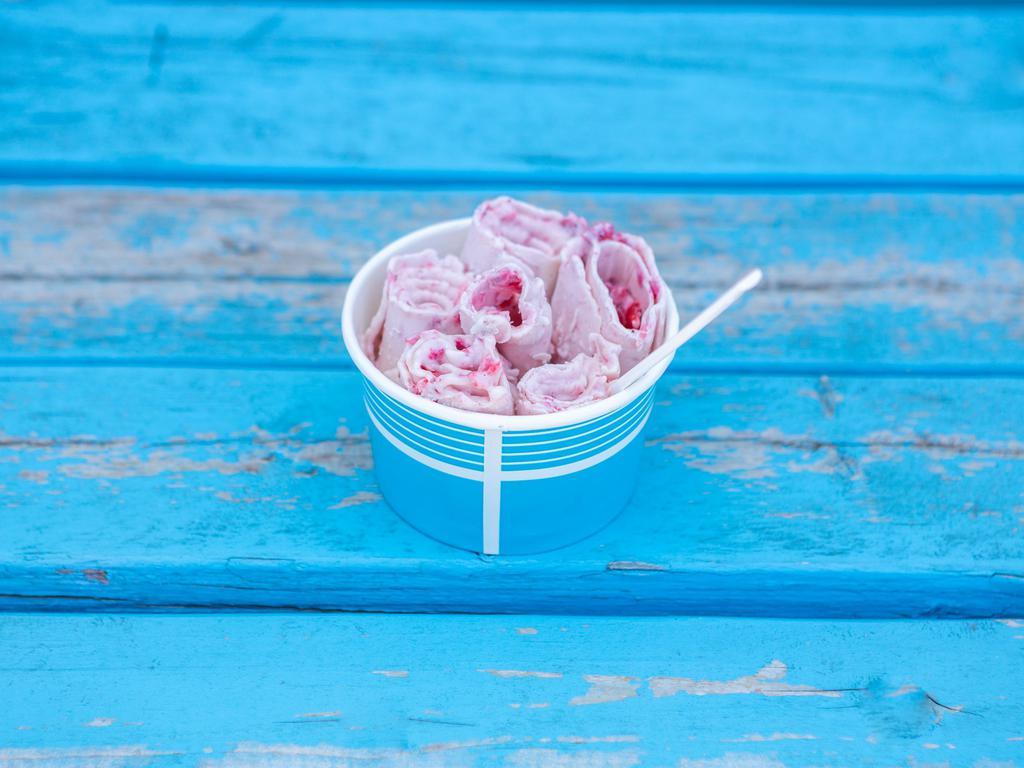 Strawberry Cheesecake Ice Cream · Vanilla ice cream base, strawberries, cheesecake, and white chocolate drizzle.