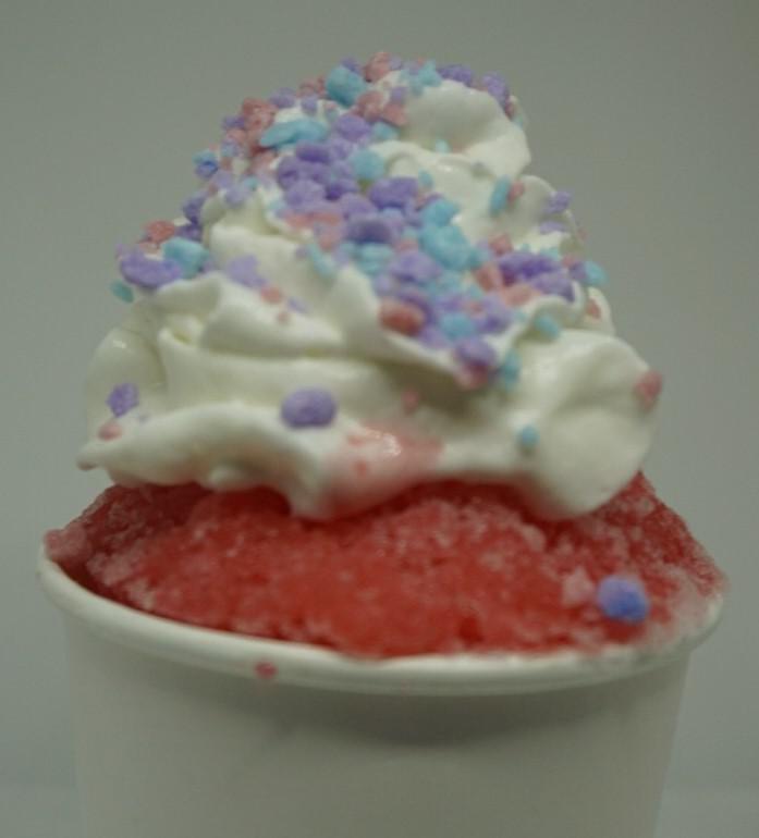 Cotton Candy Crunch Shaved Ice · Cotton candy shaved ice, a scoop of vanilla ice cream, whipped cream, and cotton candy crunch candies.