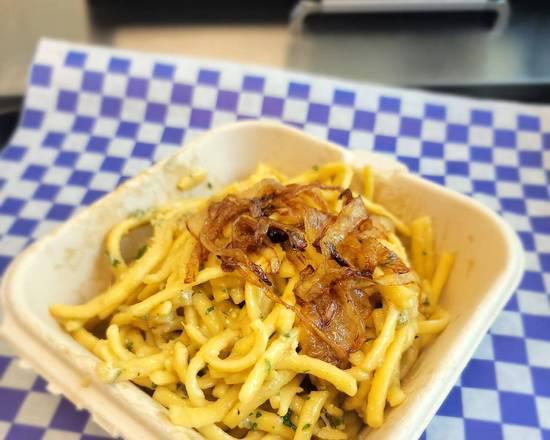 Kaese Spaetzle · Homemade German egg noodles, smothered in our  three cheese  mix topped with caramelized onions.
