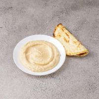Hummus · Chick pea spread, garlic, olive oil, crushed sesame seeds and flat pita bread.