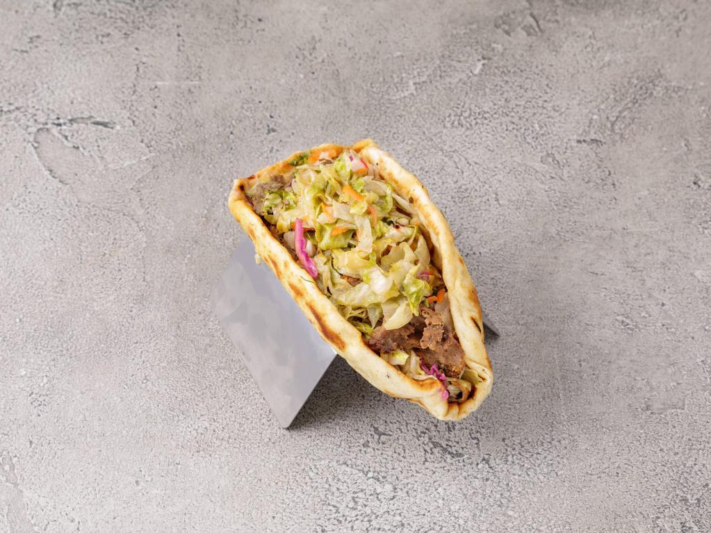 Gyro · Rotisserie cooked sliced of seasoned beef and lamb. Wrap and pita sandwiches with lettuce, tomatoes, onions, vinaigrette and side of cucumber yogurt sauce.