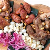 3 little pigs (Tres chanchitos) for 1 or for sharing · Slow roasted pork, juicy light fried pork ribs, chorizo, pickled onions, hominy, corn nuts