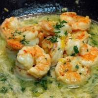 Garlic shrimp · Shrimp in garlic sauce served with yellow rice, tostones and avocado