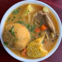 Caldo de Bola · Short rib soup, corn on the cob, green plantain ball filled with meat, served with rice