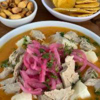 Encebollado · Fish stew, with cassava and pickled onions served with rice, banana chips and corn nuts