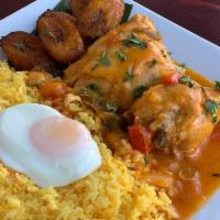 Seco de Pollo · Chicken stew served over yellow rice, fried egg, sweet plantain, avocado, mixed greens