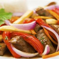 Lomo saltado (3 tacos) · Juicy steak with tacos with thin strips of red onions and tomato over fries