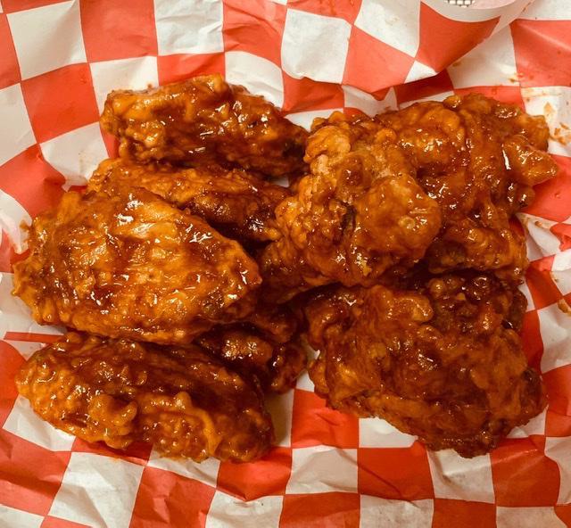 Seasoned Chicken Wings · Cooked wing of a chicken coated in sauce or seasoning.