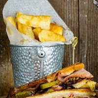 CUBAN SANDWICH · Roasted Pork, Black Forest Ham, Swiss Cheese, Garlic Mojo and French Fries.