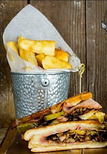 CUBAN SANDWICH · Roasted Pork, Black Forest Ham, Swiss Cheese, Garlic Mojo and French Fries.
