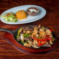 Las Tres Huasteka Special · Camaron, pollo, filet de pescado y carne asada. Roasted seasoned shrimp, chicken, fish filet...