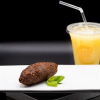Kibe (beef croquette) · Ground beef and bulgur wheat, seasoned with herbs and spices then fried.