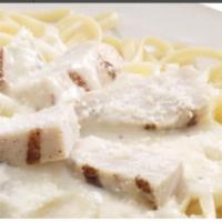Chicken Alfredo · A bed of pasta and grilled chicken strips in Alfredo sauce and finished with pecorino Romano...