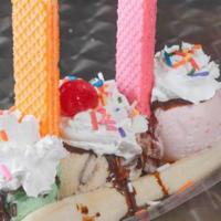 Banana Split · Includes 3 scoops of ice cream, pick your flavors from our ice cream list, whipped cream, ic...