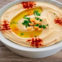 Hummus · Garbanzo beans, fresh garlic, tahini blended together topped with olive oil, paprika.