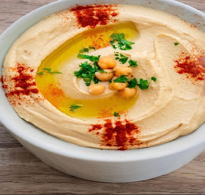 Hummus · Garbanzo beans, fresh garlic, tahini blended together topped with olive oil, paprika.