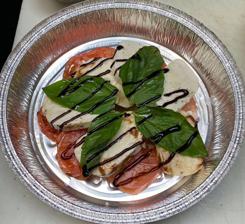 Caprese Salad · Alternating layers of thick sliced tomato, fresh mozzarella and fresh basil, seasoned and finished with extra virgin olive oil and a balsamic glaze
