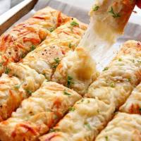 Cheesy Stix · 10 pieces of freshly baked bread covered with melted cheeses topped with Italian spices.