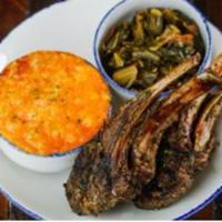 Jerk Rack of Lamb · Half a rack of lamb chops served with smoked Gouda mac and cheese and braised collard greens.