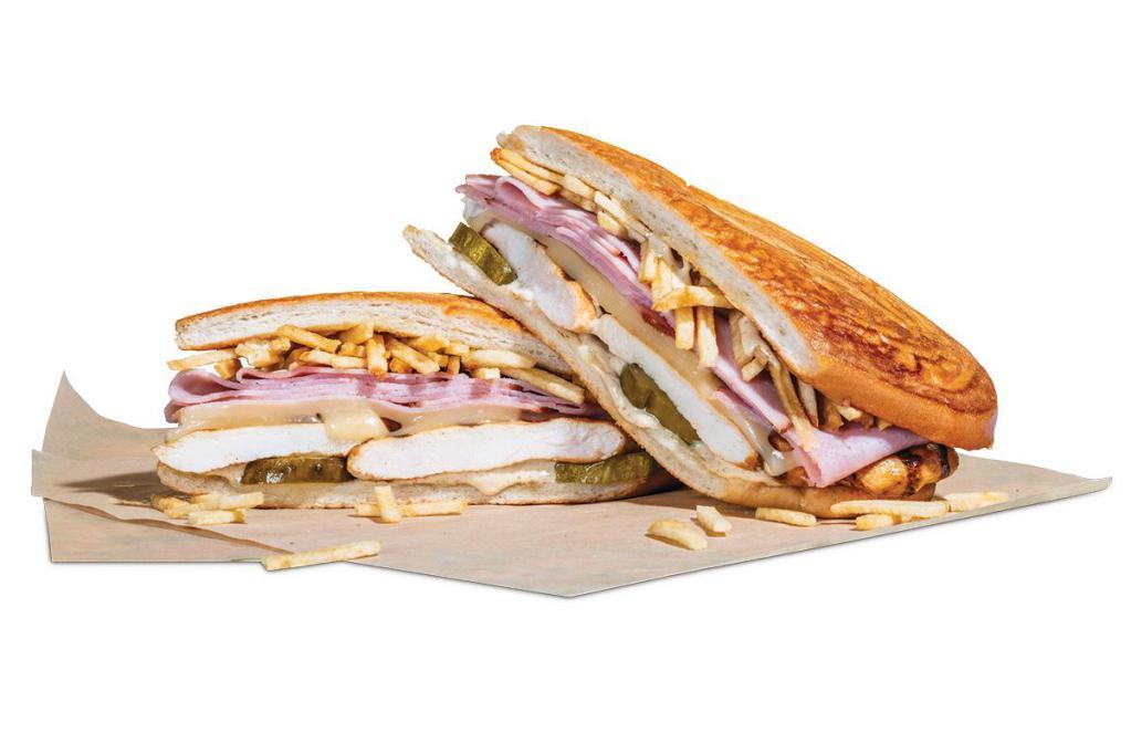 The Grilled Chicken Cuban · Grilled chicken breast and sliced ham served on a Cuban roll with Swiss cheese, potato sticks, pickles and a creamy mustard spread.