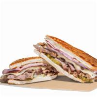 The Cuban Sandwich Combo · Mojo Roast Pork and sliced ham together on a Cuban roll with Swiss cheese, pickles and a cre...