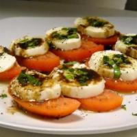 Caprese Salad · Fresh mozzarella, tomatoes seasoned with olive oil, balsamic vinegar salt, and pepper.