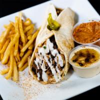 Steak Shawarma · This is our juicy and seasoned steak shawarma, comes with garlic and tahini sauce wrapped in...