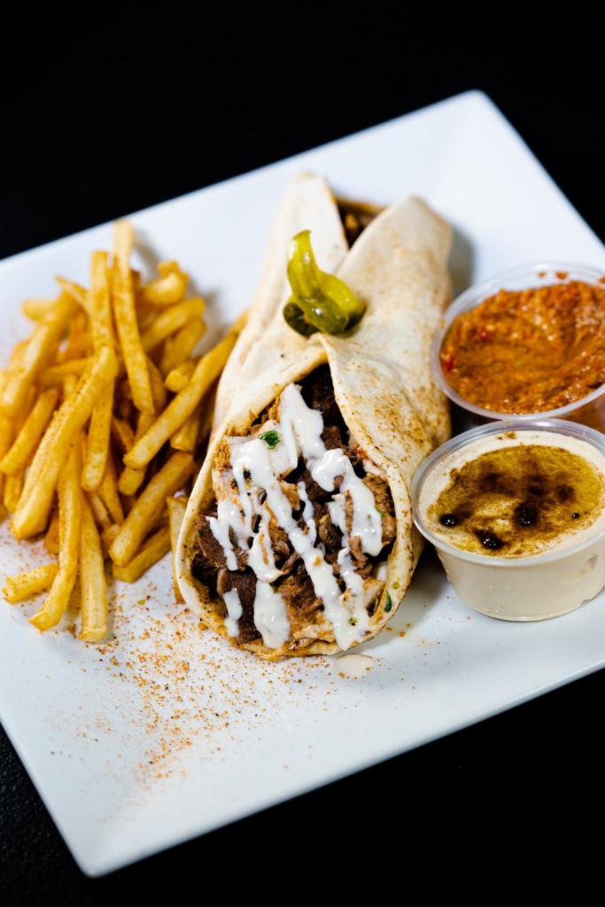 Shawarma Mix · This is our juicy and seasoned steak and chicken shawarma, comes with garlic and tahini sauce wrapped in pita bread. 
