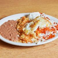 Chilaquiles Rojos con Huevo, Crema, Queso Fresco, Arroz y Frijoles · Shredded Tortillas in Red Sauce with Eggs, Cheese, Sour Cream Served with Rice and Beans