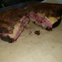 Pastrami and Swiss Sandwich · Hot or cold. Sliced pastrami with melted Swiss cheese on swirled rye bread. Topped with toma...