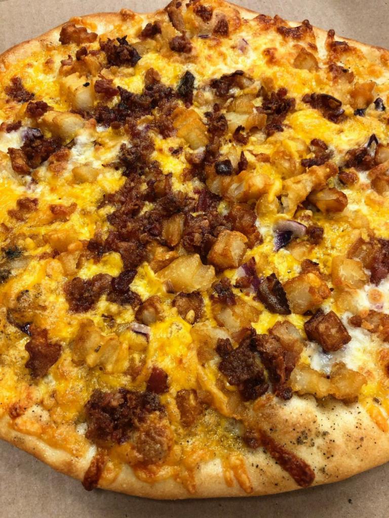 Loaded potato pizza · Garlic sauce, mozzarella cheese, French fries, cheddar cheese, red onions, topped with crispy bacon and a side of sour cream. 