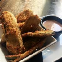 Fried Pickles · Crunchy house breaded pickles served with CAH sauce.