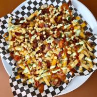 Loaded Fries · Our Belgian style fries topped with bacon, cheddar, roasted corn pico de gallo, ancho chipot...