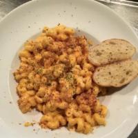 Homestyle Mac-N-Cheese · Cavatappi pasta in a creamy cheese sauce, topped with toasted bread crumbs and garlic toast.