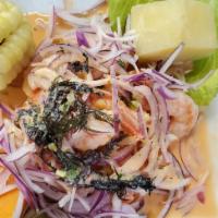 Ceviche de Camarones · Shrimp marinated on lime juice, mixed with red onions, cilantro and rocoto hot sauce.