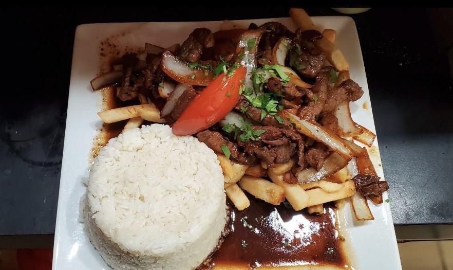 Lomo Saltado · Tender beef saute with onions, tomatoes in a soy sauce. Served with French fries, and white rice.