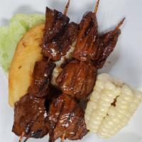 Anticuchos · Peruvian style brochettes and cut stew meat from beef heart on the grill. Served with boiled...
