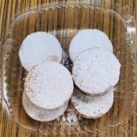 Alfajores · Sweet cookies with white powder and caramel.